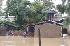 Egy férfi Nepál délkeleti részén az árvízből próbálja menteni megmaradt holmiját. (CSI)